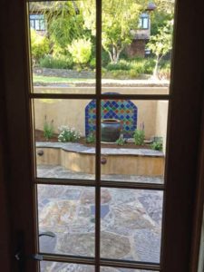 Looking out to enclosed front patio and fountain