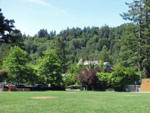 Park in Ross, CA with view of Victorian house and hills